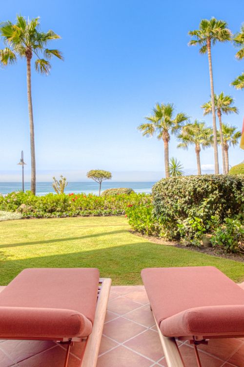 Impeccably renovated, south facing beach front, garden apartment located in the exclusive Menara Beach community on the sought-after New Golden Mile