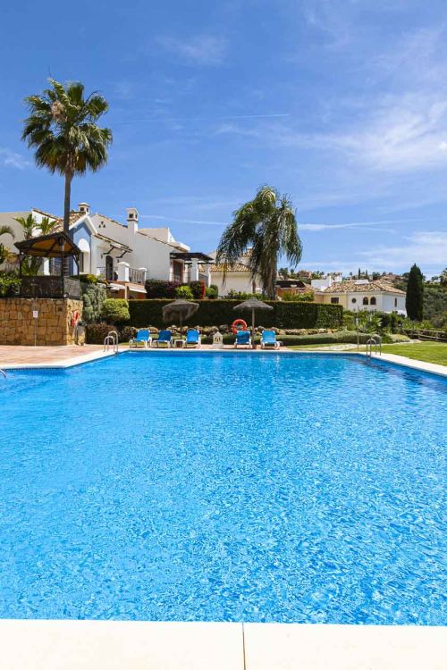 Beautiful south-facing, four bedroom townhouse in Los Almendros, part of the secure Los Arqueros Golf community in Benahavís