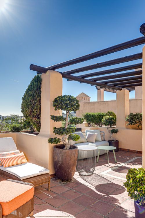 Mediterranean-style duplex penthouse with multiple terraces and a rooftop terrace with a private sauna and barbecue area